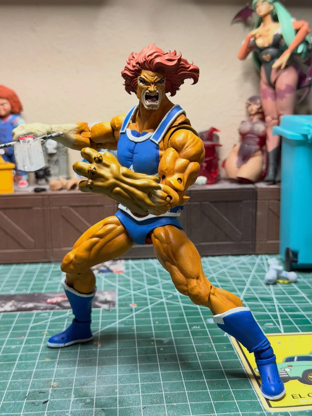 The custom Lion-O lunging low with the sword thrust out to one side and the claw shield forward, mouth open in a roar