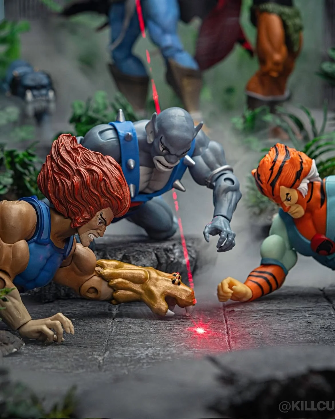 Tight crop of the finished photograph showing Lion-O, Panthro and Tygra converging on the red dot in the haze