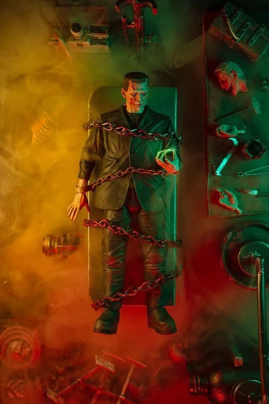 Frankenstein's monster standing in a laboratory lit green and red