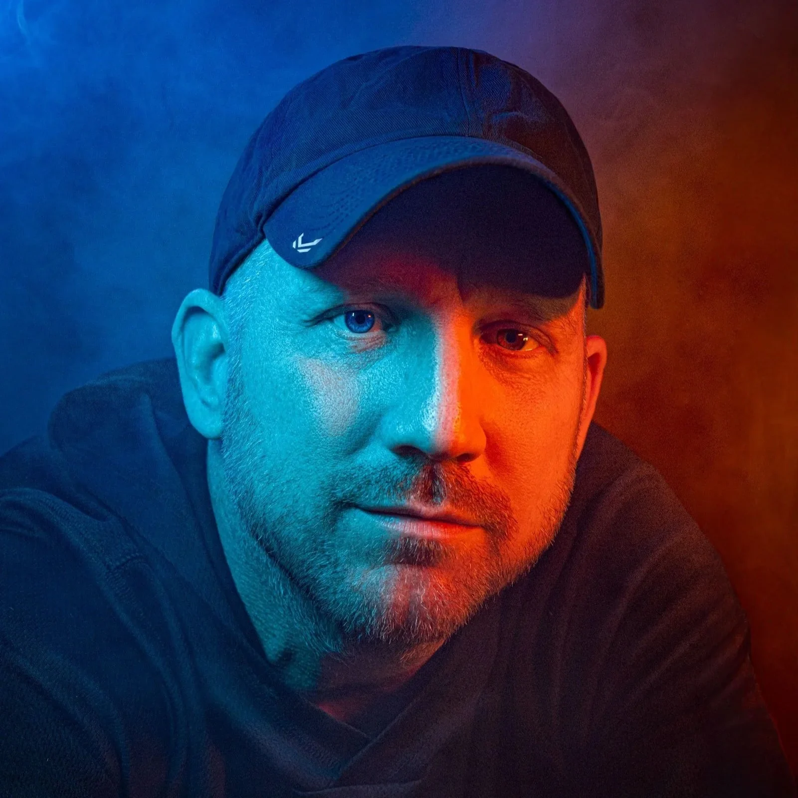 Portrait of Chuck Eiler, the photographer who works as Killcutter, lit with blue and orange rim light