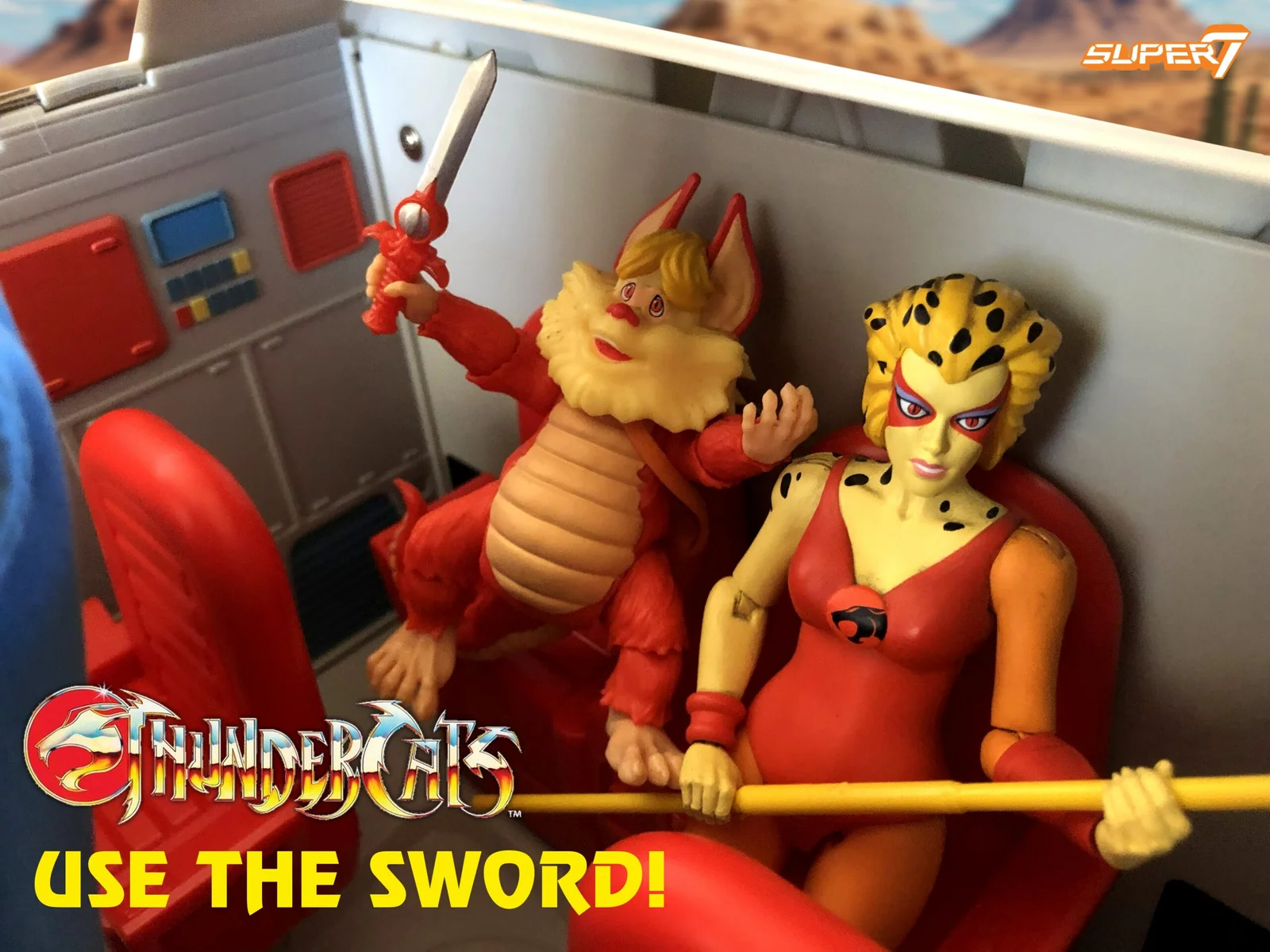 Snarf and Cheetara seated in the red interior of the Toy Color ThunderTank