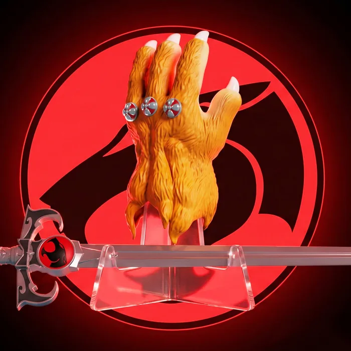 Three quarter view of the Soap Studio Claw Shield gauntlet above the Sword of Omens