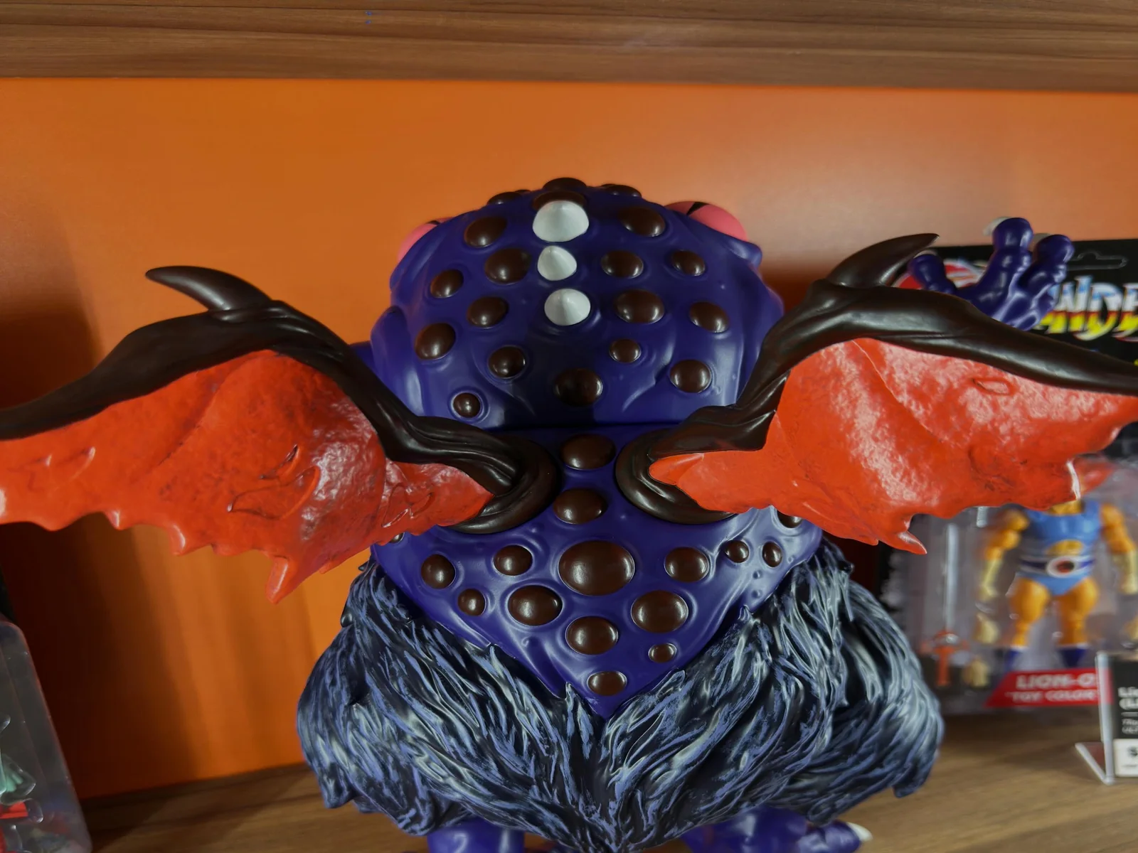 The Astral Moat Monster red bat-wings and studded back