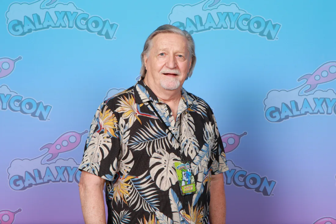 Larry Kenney meets a fan at his photo-op table, GalaxyCon Raleigh 2024